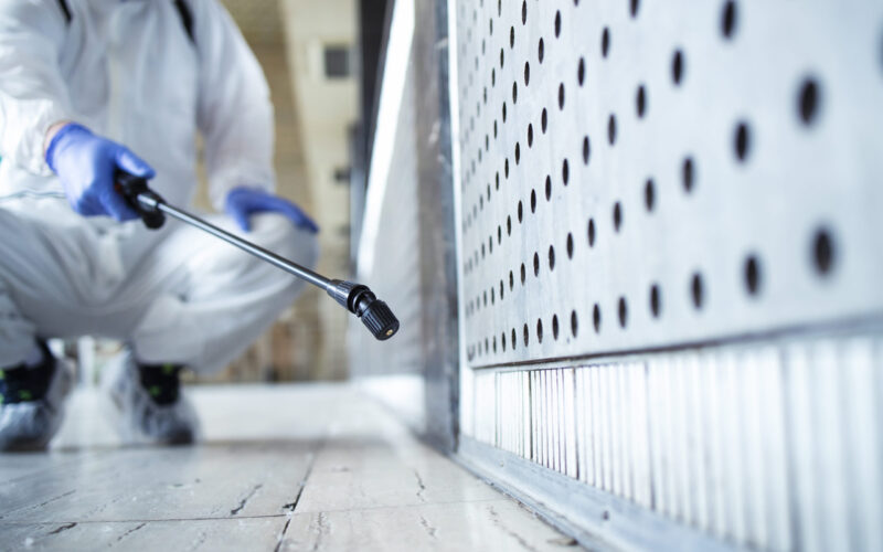 A picture of a man spraying pesticide